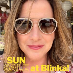 women in sunglasses with wording sun sale at blinka printed on the photo.